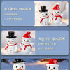 A set of white resin snowman figurines with red hats and scarves standing in snow.