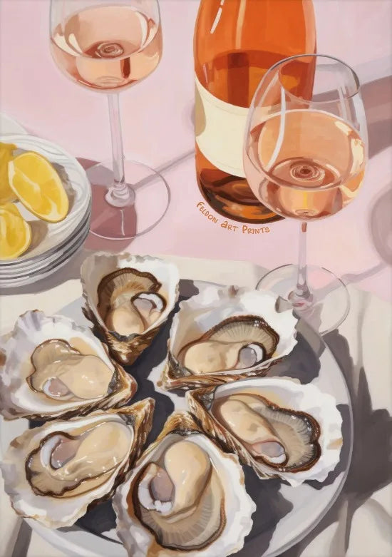 A still life featuring a glass of rosé wine, lemons, and several oyster shells on a plate.