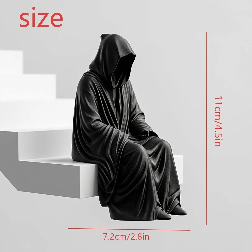 Black hooded figure bookend with a draped fabric texture shown in a side view.