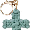 A teal woven cross keychain with a gold-toned metal clasp and circular ring.