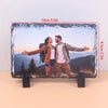 A rectangular slate photo frame displaying a couple outdoors with mountains in the background.