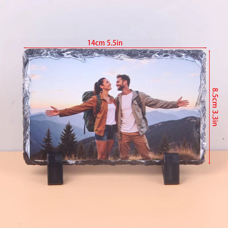 A rectangular slate photo frame displaying a couple outdoors with mountains in the background.