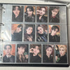 A large capacity grid binder filled with numerous photocards featuring male K-pop idols.