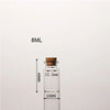 A clear glass bottle with a cork stopper and a measuring scale indicating 8ML volume.