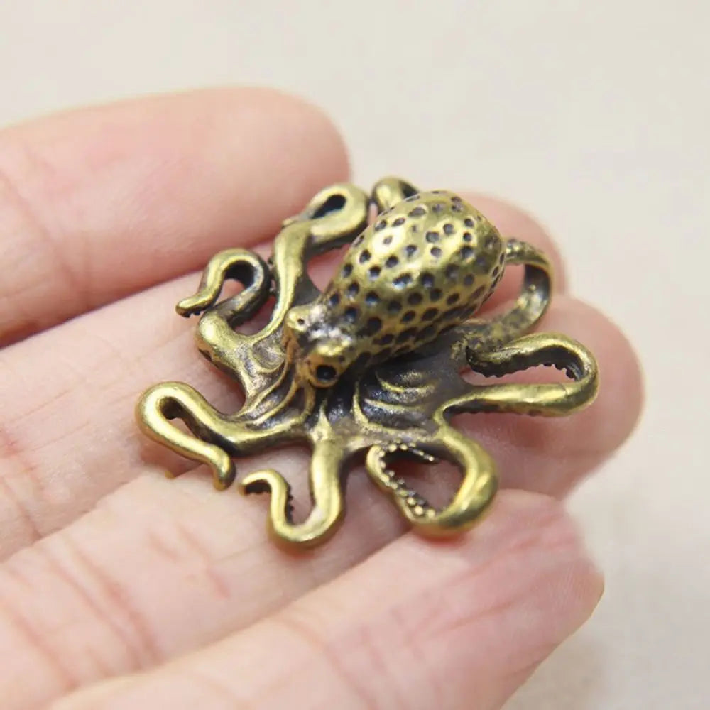 Antique brass octopus desk ornament with detailed texture and curled tentacles