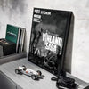 A poster of Vinland Saga anime featuring a dramatic scene, displayed next to a box and on a white surface.