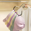 A set of metal hat storage hooks displaying various colored hats hanging on a wooden rack.