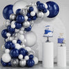 A balloon garland arch featuring navy blue, silver, and white balloons displayed on a white pedestal.