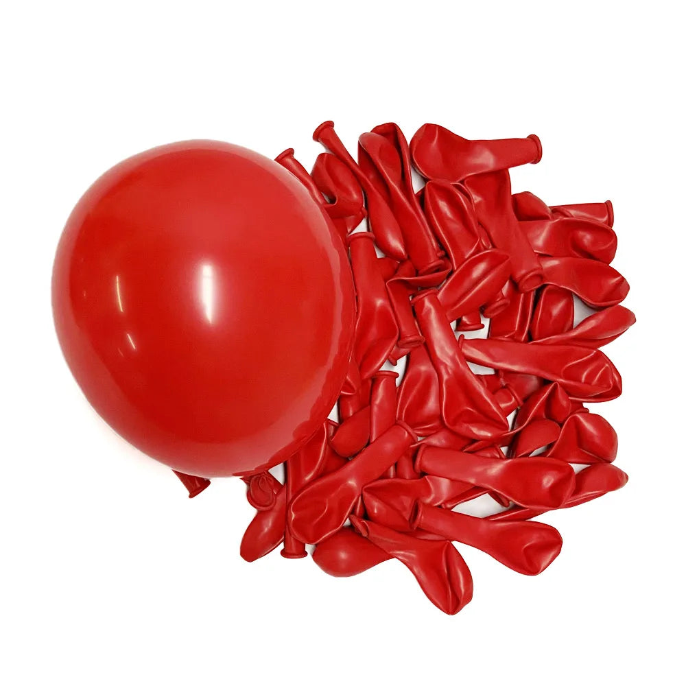 A cluster of vibrant red latex balloons scattered on a white background.