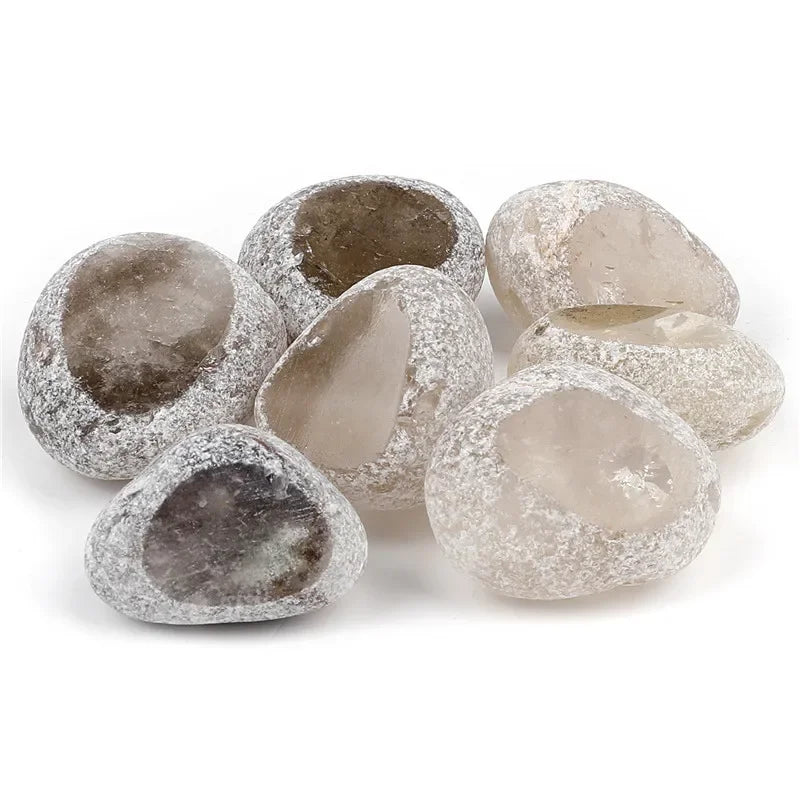A collection of tumbled natural crystals including clear quartz, rose quartz, and amethyst stones.