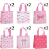 Set of pink and white gift bags featuring various bow and heart cutouts