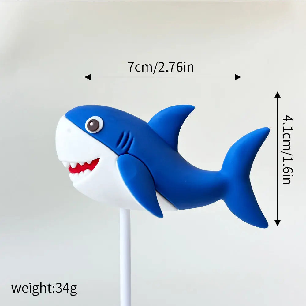 A white and blue whale cake topper with a tail, measuring 7cm long.