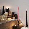 A collection of four gothic vampire tear taper candles with a dripping blood effect displayed on a stone ledge.