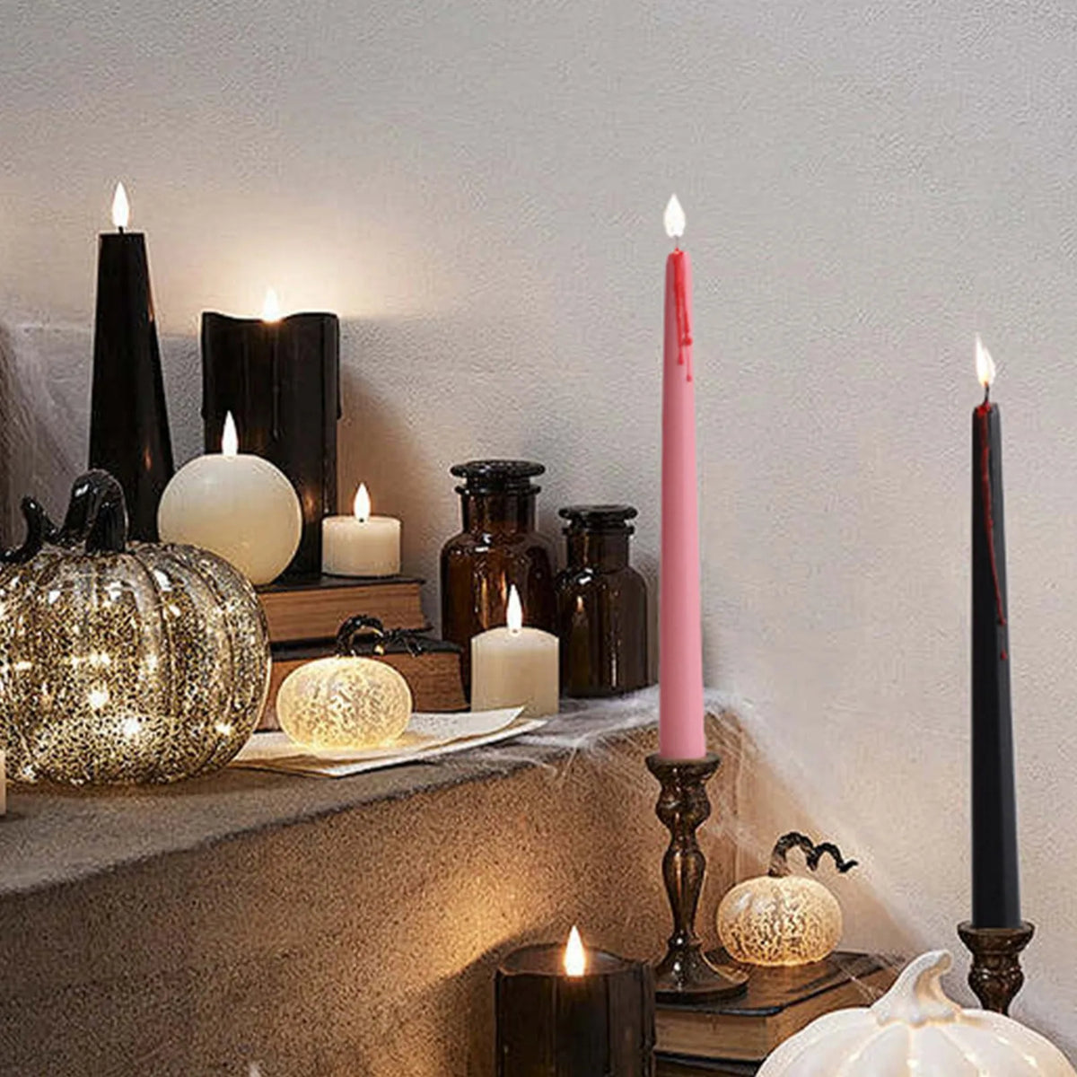 A collection of four gothic vampire tear taper candles with a dripping blood effect displayed on a stone ledge.