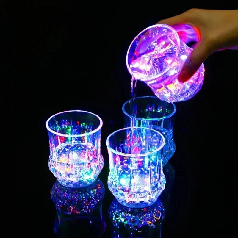 A hand is pouring glowing purple liquid into a glass cup, creating a vibrant light display.