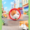 A round red magnet featuring cute bear and panda collectible dolls set against a blurred city street background.