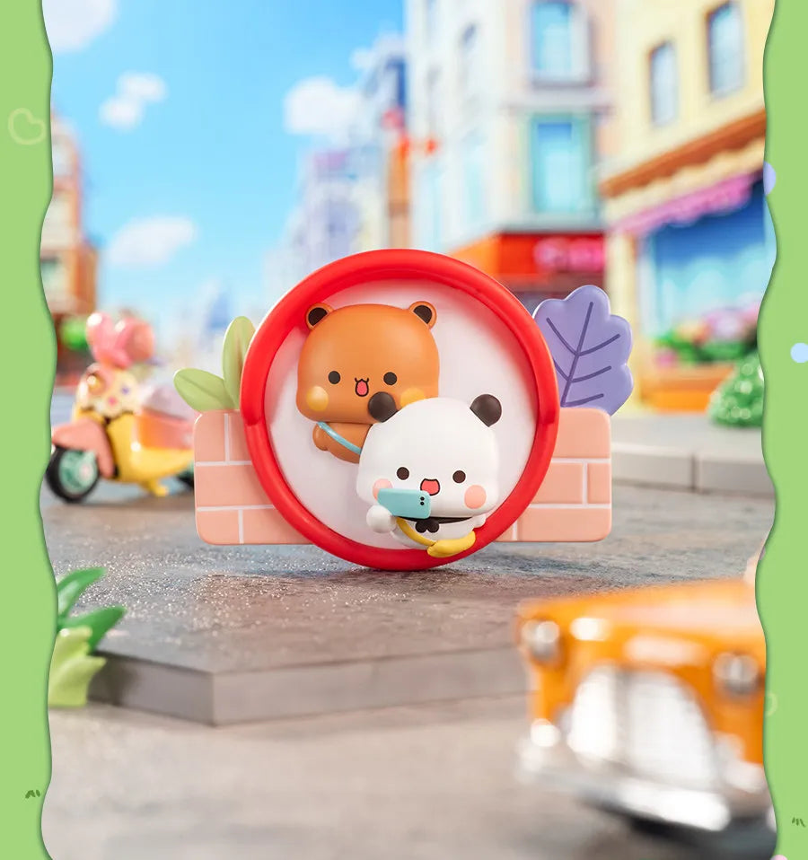 A round red magnet featuring cute bear and panda collectible dolls set against a blurred city street background.