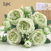 A bouquet of light green and white artificial roses and peonies for decoration.