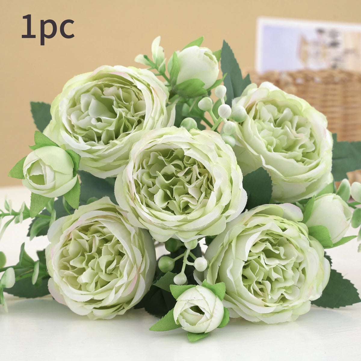 A bouquet of light green and white artificial roses and peonies for decoration.