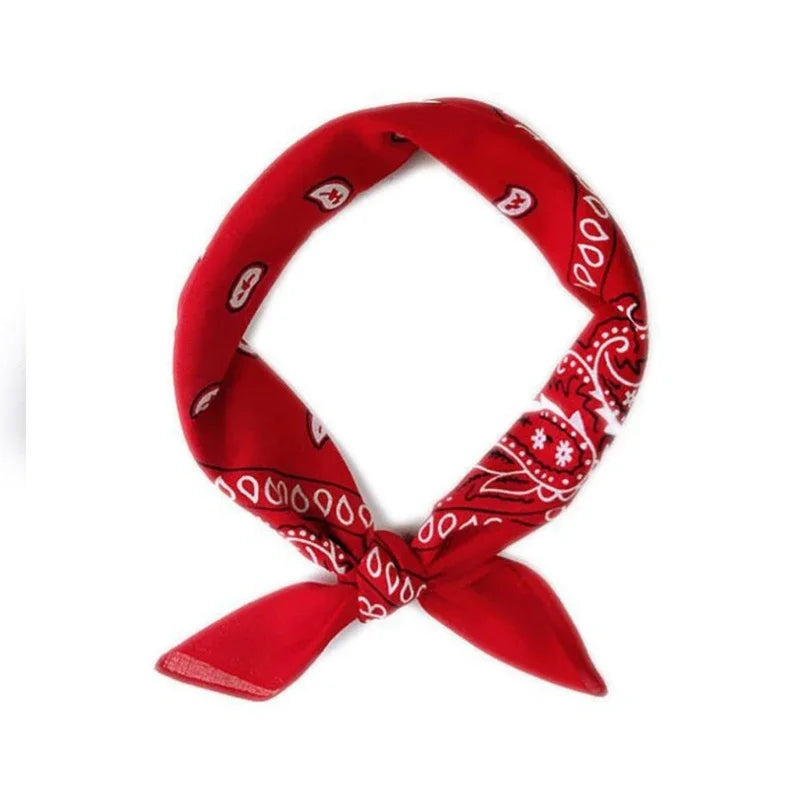 A red bandana tied in a bow with white paisley patterns, part of a classic cowboy costume set.