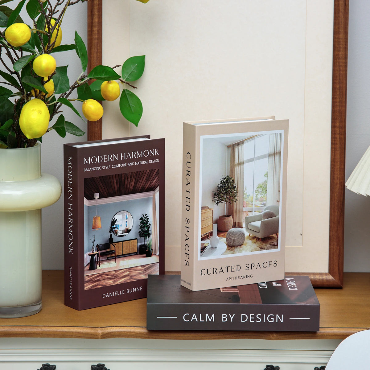 A set of three books featuring modern interior design and space concepts displayed on a wooden surface.