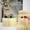 A tiered folding dessert table display featuring various heights of cupcakes and desserts.