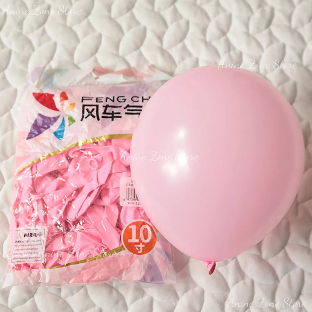 A pink latex balloon is shown next to a package of pastel pink balloons for party decorations.