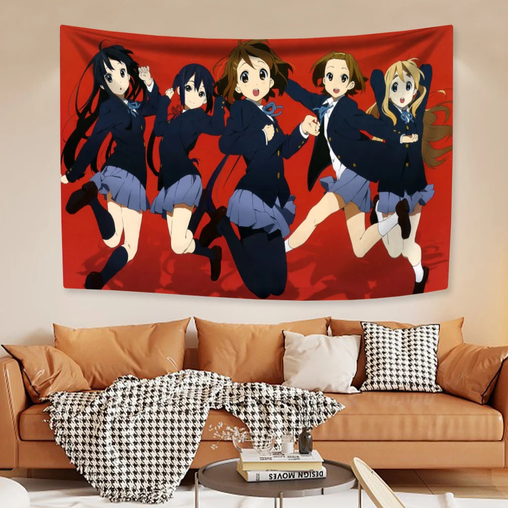A wall tapestry featuring characters from K-ON! anime in dynamic poses against a red background.
