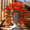A vibrant arrangement of artificial red morning glory hanging vines in a gray urn for garden decor.