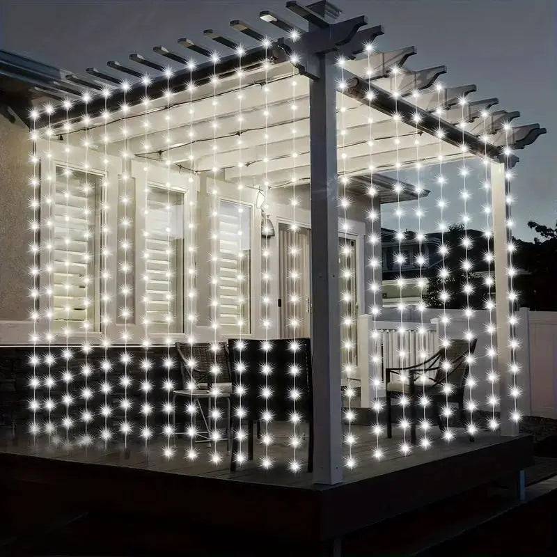 Exterior view of a house featuring string lights draped across the facade and porch area.