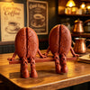 A 3D printed coffee bean cup figurine with articulated joints, brown in color, displayed on a wooden table.