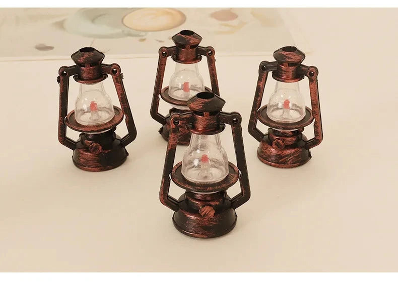 Three vintage ceramic miniature lanterns with glass bulbs and metal frames for dollhouse décor