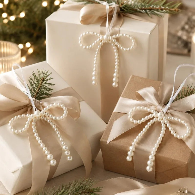 A set of elegant pearl bow Christmas tree ornaments wrapped in light kraft paper and tied with natural twine.