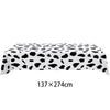 Black and white cow print table cloth for farm-themed birthday parties