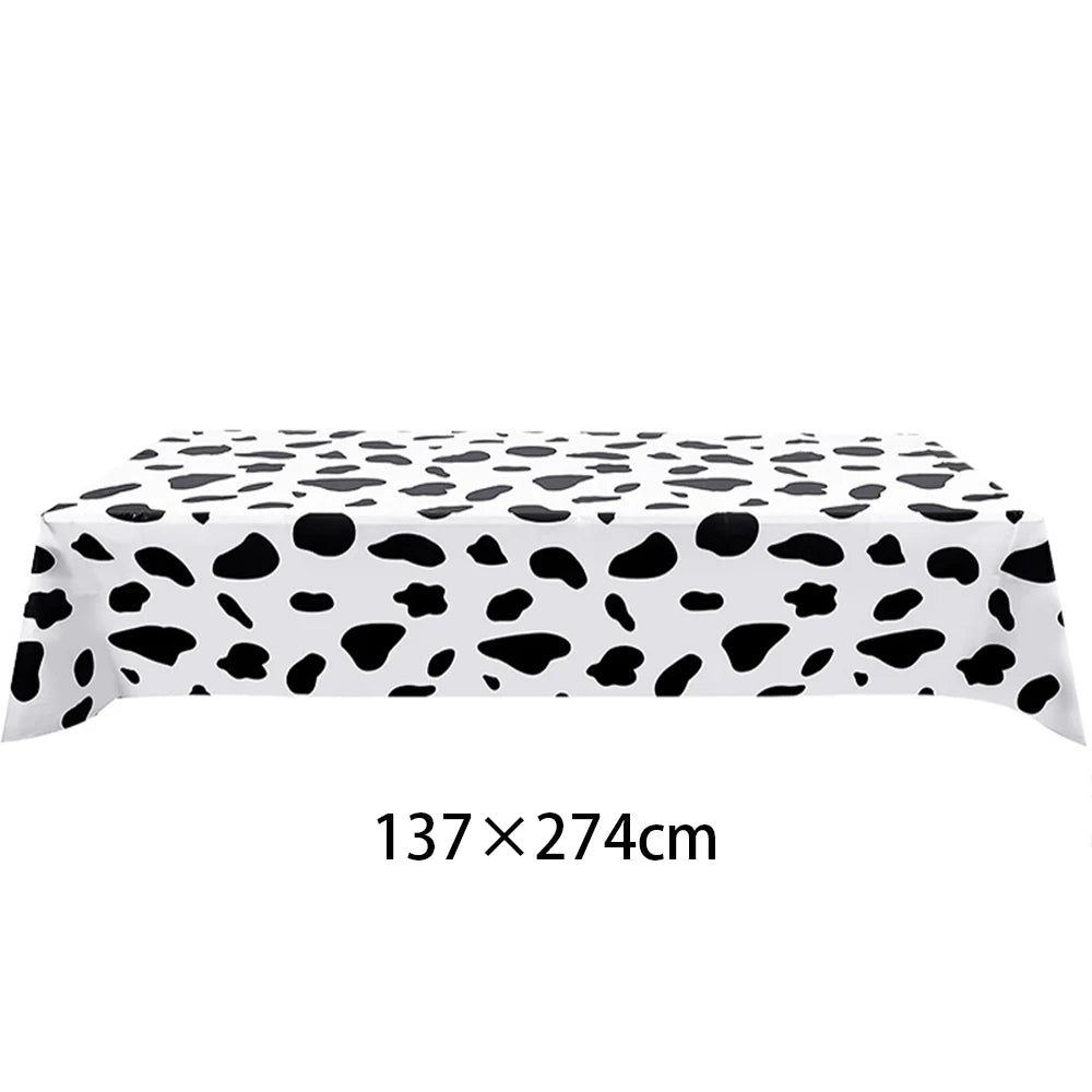 Black and white cow print table cloth for farm-themed birthday parties