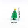 A small, green, Christmas tree-shaped figurine with a yellow star on top.