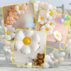 A collection of elegant white and peach daisy balloons arranged in decorative garlands for summer celebrations.