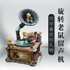 A vintage carousel music box decoration featuring a small figurine of a bear on top.