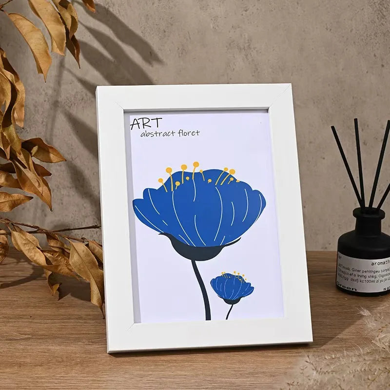 A white frame holds an abstract blue flower illustration on a light background.