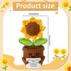 Handcrafted crochet plant featuring a yellow flower and green leaves, with a small dog figure at the base.