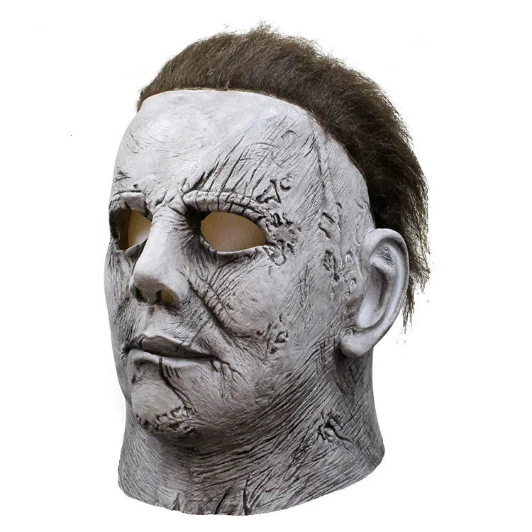 A realistic gray latex horror mask resembling Michael Myers with distressed skin and dark hair.
