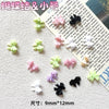 Colección de mini charmes de uñas en forma de tortuga de colores rosa, verde y negro sobre fondo blanco