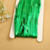 Green metallic tinsel foil fringe curtain backdrop for parties displayed on a white card.