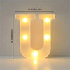 A glowing yellow letter U made of LED lights, used for cozy room or party decor.