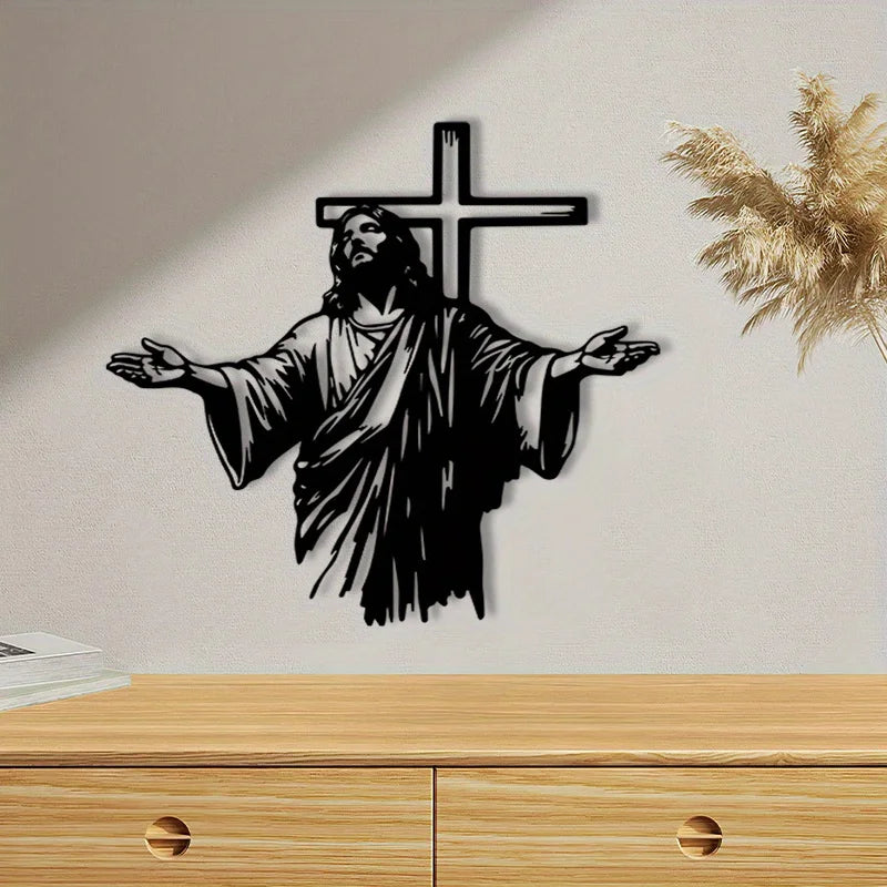 Black silhouette of Jesus with outstretched arms and a cross on a light gray wall.