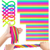 A hand is holding a colorful set of stretch sensory fidget toys, including coiled and striped silicone bands.