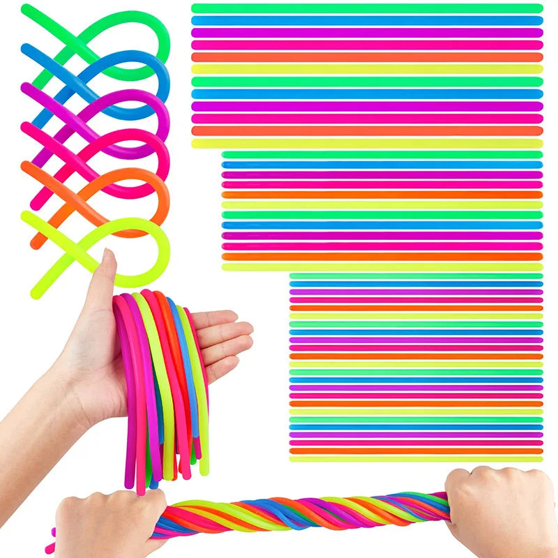 A hand is holding a colorful set of stretch sensory fidget toys, including coiled and striped silicone bands.