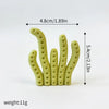 A set of three light green ocean animal cake toppers, including a whale, octopus, and turtle.