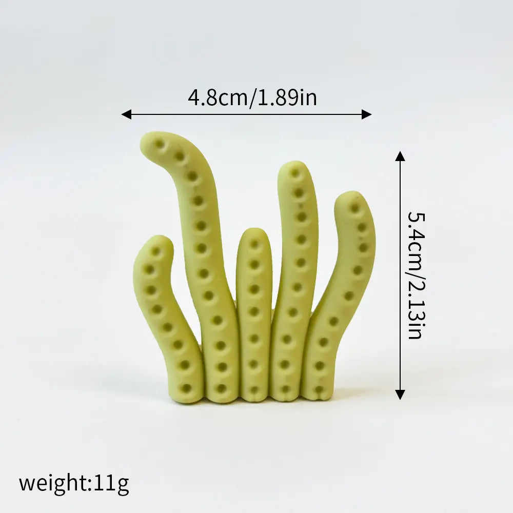 A set of three light green ocean animal cake toppers, including a whale, octopus, and turtle.