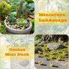 A miniature landscape featuring golden duck resin statues in a potted succulent garden.